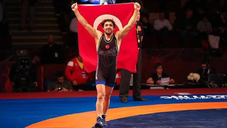 Turkish wrestler, Atakan Yuksel holds Turkish flag high during 2019 European Wrestling Championships.