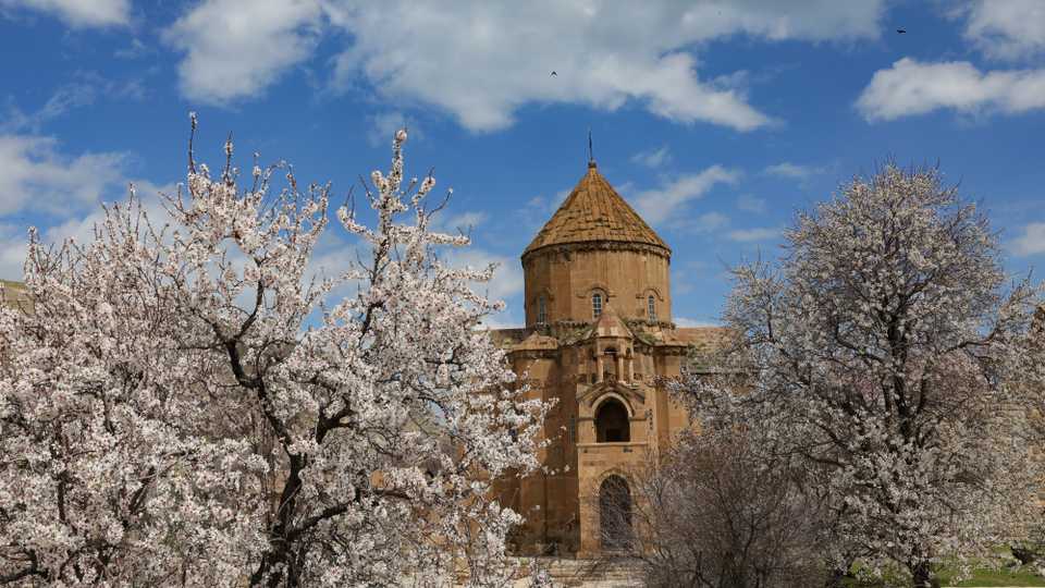 Historical Akdamar church is seen with trees in blossoms at Akdamar Island on Lake Van during spring time in Turkey's Van province on April 11, 2019.
