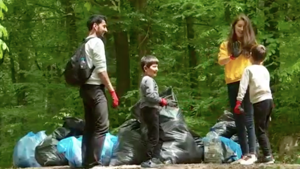 A group of volunteers and their children collect garbage in Belgrad forest, Istanbul.
