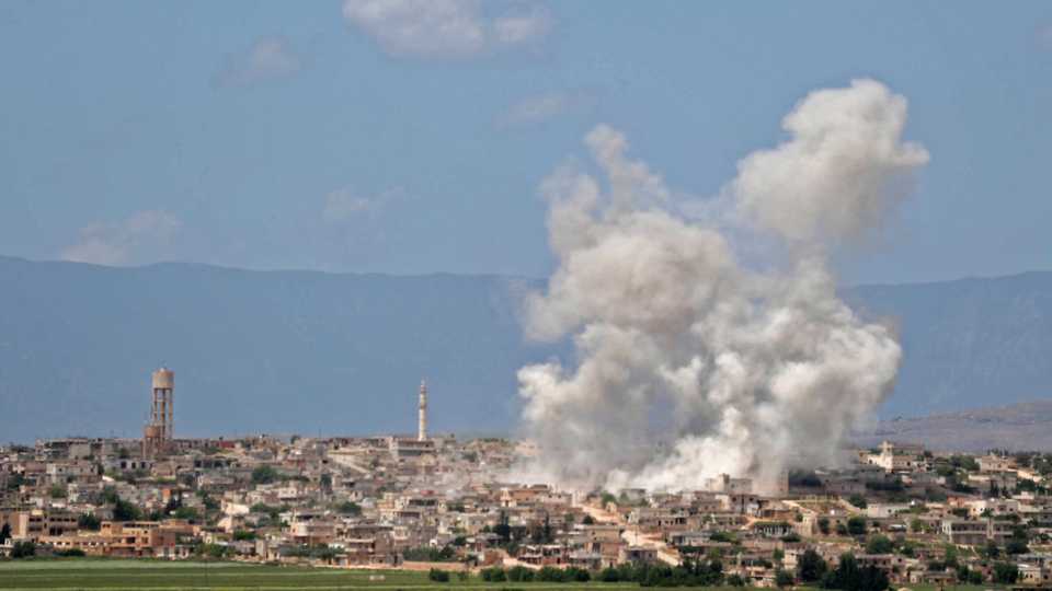 Smoke billows above building during reported shelling by regime and allied forces, in the town of Hbeit in the southern countryside of the rebel-held Idlib province on May 3,2019.