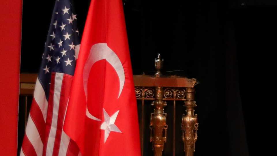 A photo shows flags of Turkey and the US.