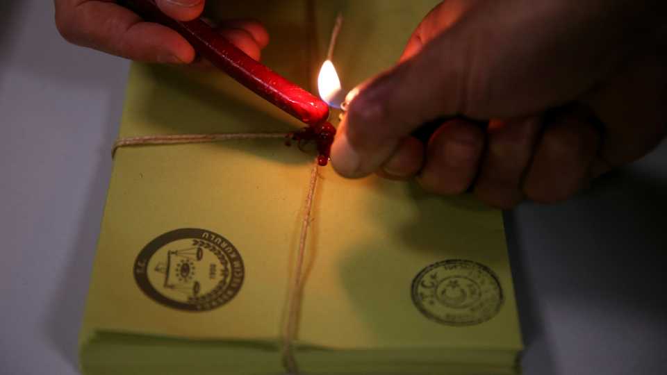 File photo shows Turkish election officials sealing the vote envelops, shortly after the polling stations closed at the end of the election day, in Istanbul, Sunday, Nov. 1, 2015.