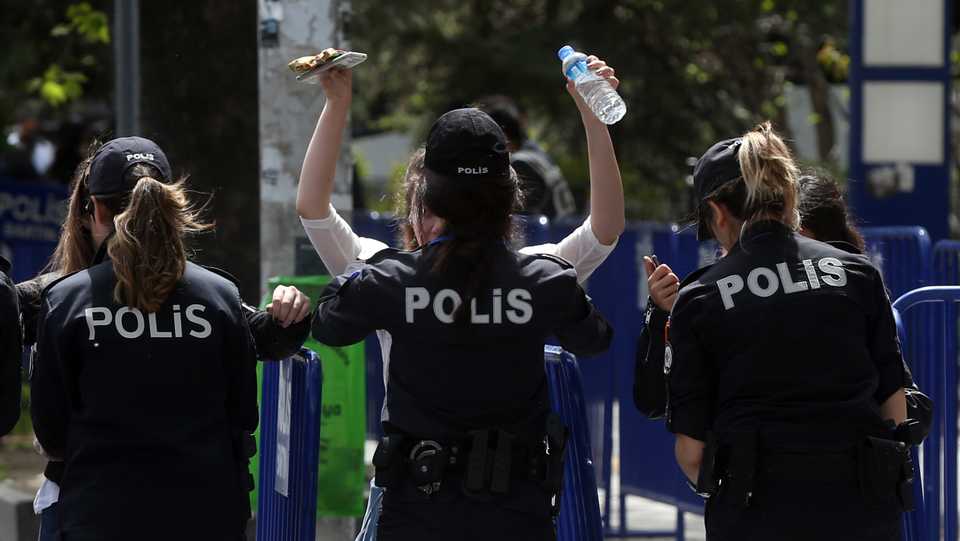 In this file photo, police officers take security measures as people take part in International Workers' Day, also known as May Day celebrations in Ankara, Turkey. (May 1, 2019)