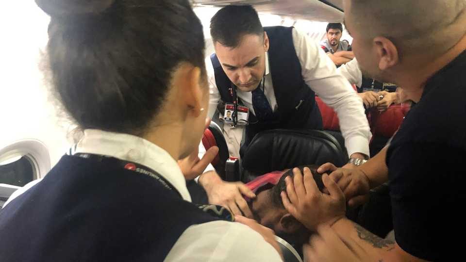 The scene as Associated Press photographer Hussein Malla observes as passengers and crew aboard a Turkish Airlines jetliner subdue a man who started screaming a few minutes after takeoff from Istanbul.