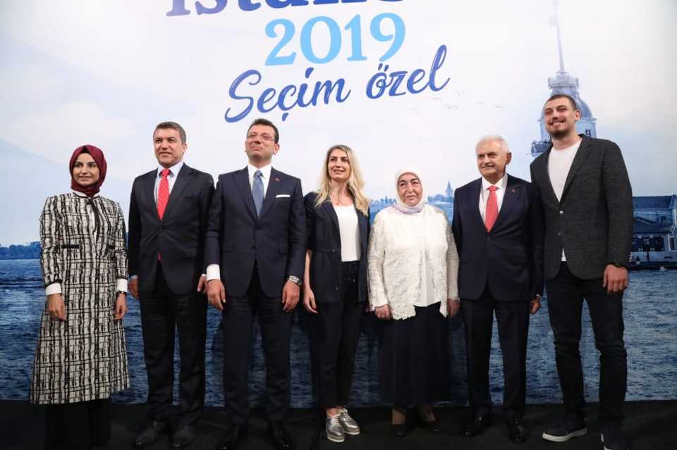 Istanbul mayoral candidate of governing Justice and Development (AK) Party, Binali Yildirim (2nd R), his wife Semiha Yildirim (3rd R), his daughter Busra Koylubay (L), Istanbul mayoral candidate of main opposition Republican People’s Party (CHP), Ekrem Imamoglu( 3rd L), his wife Dilek Imamoglu (4th L) and his son Selim Imamoglu (R) pose for a photo after the live televised debate moderated by journalist Ismail Kucukkaya (2nd L), at Istanbul’s Lutfi Kirdar Congress Center, on June 16, 2019 in Istanbul, Turkey.
