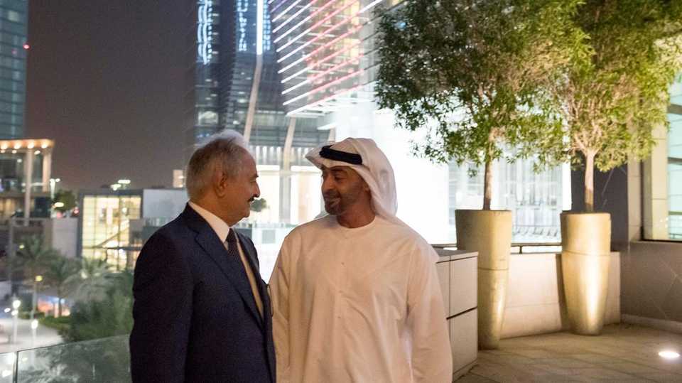 A handout image provided by United Arab Emirates News Agency (WAM) shows Abu Dhabi Crown Prince Mohammad bin Zayed al-Nahyan (R) posing for a photograph with Libya's Khalifa Haftar, the head of the self-proclaimed Libyan National Army, on July 8, 2017, in Abu Dhabi.