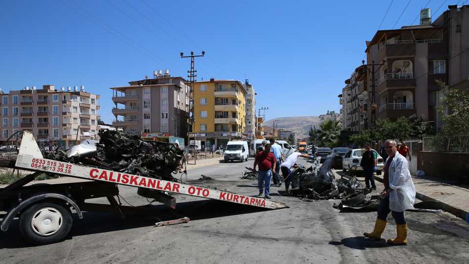 Security and forensic officials work at the site after an explosion inside a vehicle in Reyhanli, Turkey, Friday, July 5, 2019.