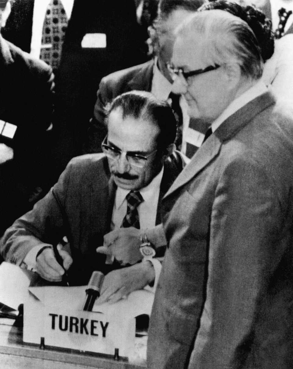 Greek and Turkish delegates to the Cyprus peace conference sign an accord they arrived at after six days of negotiations on July 31, 1974 in Geneva after Turkey’s successful military intervention to the island. Foreign Minister Turhan Gunes of Turkey signs while British Foreign Office secretary James Callaghan stands at right.