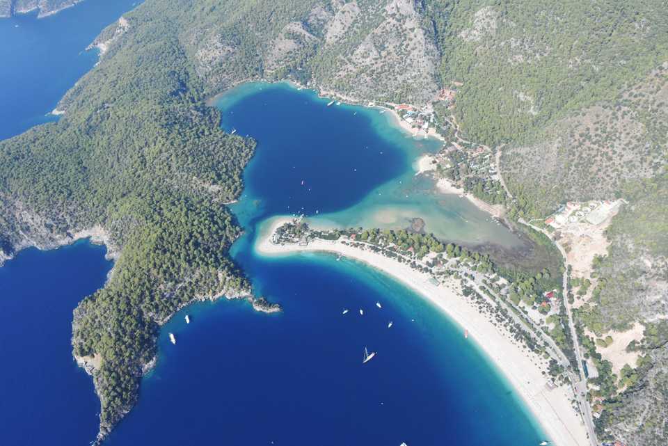An aerial view of a beach and vessels at the shore of Oludeniz from 1,700 meters high track at the Babadag Air Sports and Recreation Center in Fethiye district of Mugla, Turkey on October 16, 2018. Oludeniz attracts many tourists interested in air sports as it offers views of nature along with the sea.