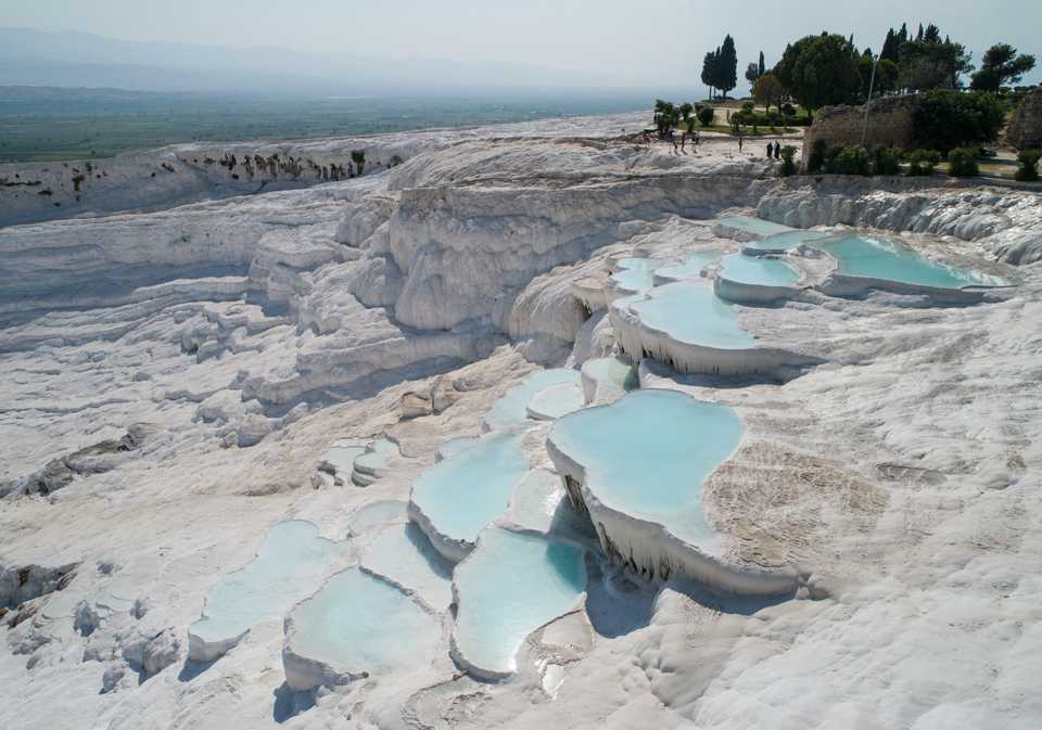 A view of the layers of limestones and travertines at the UNESCO World Heritage Site of Pamukkale in the ancient city of Hierapolis on August 11, 2018 in Denizli, Turkey. Thermal water have been running at Pamukkale for 2500 years. Despite the hot weather, layers of limestones and travertines of Pamukkale attract many tourists.