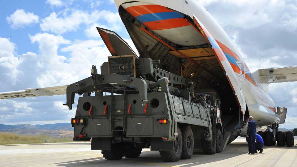 Military vehicles and equipment, parts of the S-400 air defence systems, are unloaded from a Russian transport aircraft, at Murted military airport in Ankara, Turkey, Friday, July 12, 2019.