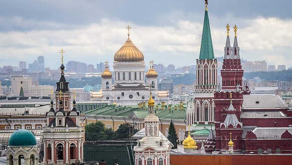 This photo taken on July 8, 2018 shows the Kremlin and the Cathedral of Christ the Saviour (C-Back) in Moscow.