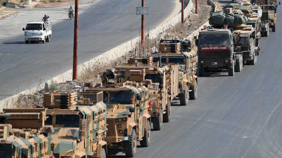 A convoy of Turkish military vehicles passes through Maaret al Numan in Syria's northern province of Idlib heading toward the town of Khan Shaykhun in the southern countryside of the province, on August 19, 2019.