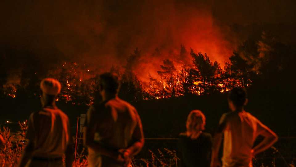Flames and smoke rising in a fire that broke out in Izmir province on Turkey's Aegean coastline on August 19, 2019. Fire brigades crew continue their works.