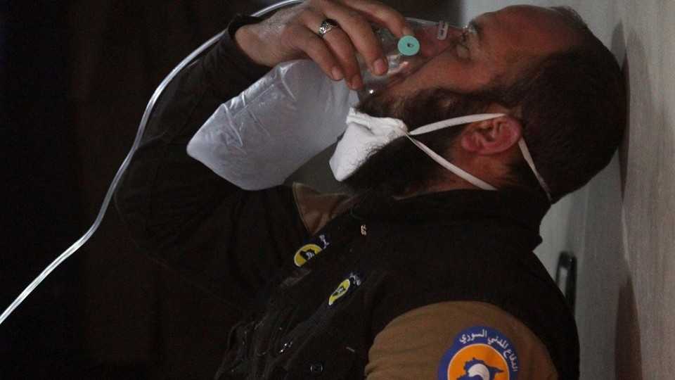 A civil defence member breathes through an oxygen mask, after what rescue workers described as a suspected gas attack in the town of Khan Sheikhoun in rebel-held Idlib, Syria April 4, 2017. 