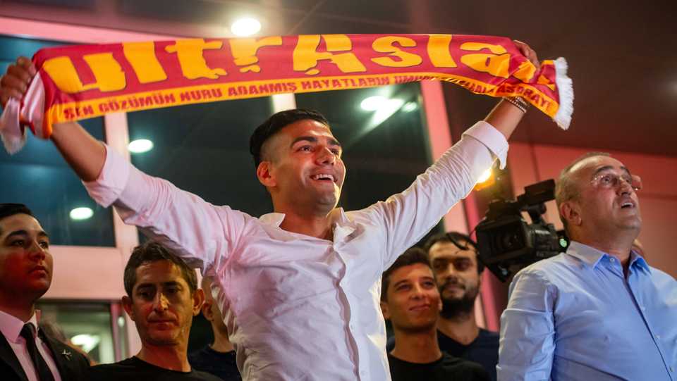 Colombian striker Radamel Falcao holds up a Galatasaray fan scarf as he arrives at Ataturk Airport in Istanbul on September 1, 2019, after French L1 AS Monaco allowed the 33-year-old to travel to Istanbul to conclude his transfer to the Galatasaray Turkish club.