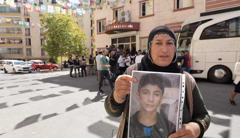 Necla Cur holds a photograph of her son Suleyman, who was just 15 years old when he was recruited by the PKK.