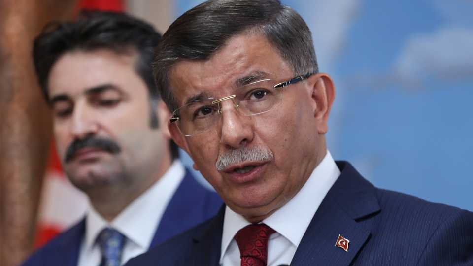Former Turkish prime minister and AK Party chairman Ahmet Davutoglu (R) holds a press conference at his office in Ankara on September 13, 2019 to announce that he would launch a 