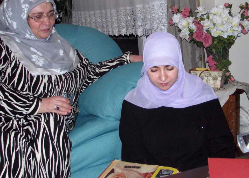 Senler (L) looks on her niece, Aysenur Alev Yilmaz (R), when she was looking at hijab models of Seher Vakti, a magazine published by Senler first in November 1969. The undated picture is taken in 2013.