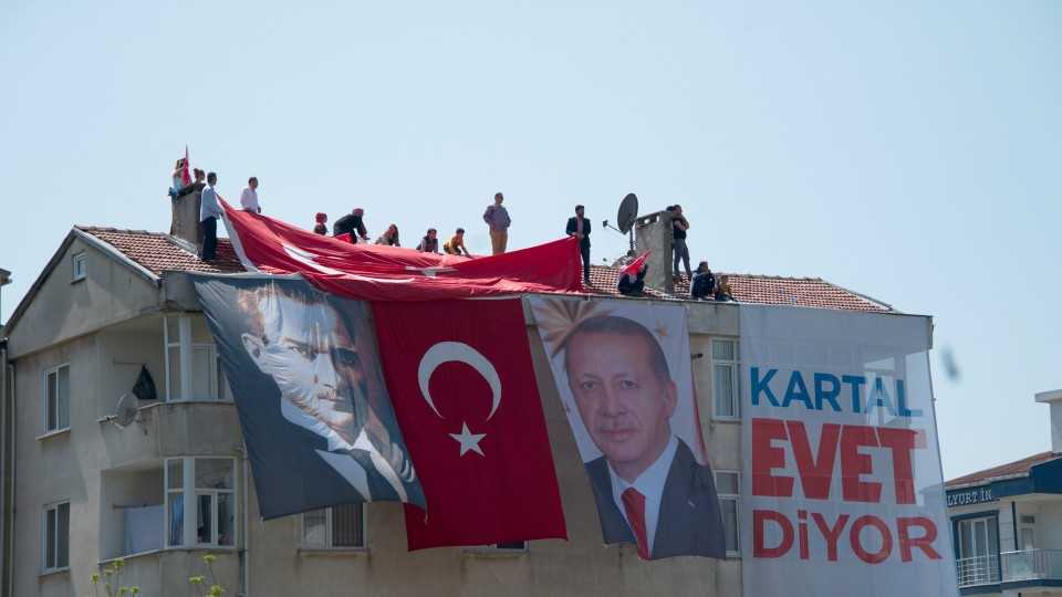 Supporters in favour of constitutional amendments listen to Turkey's President Recep Tayyip Erdogan speak in an Istanbul neighbourhood.
