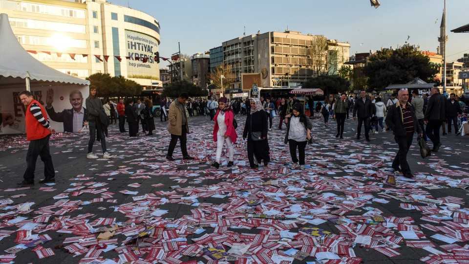People walk over leaflets reading "yes" strewn on the ground in Kadikoy district, Istanbul. (April 16, 2017)