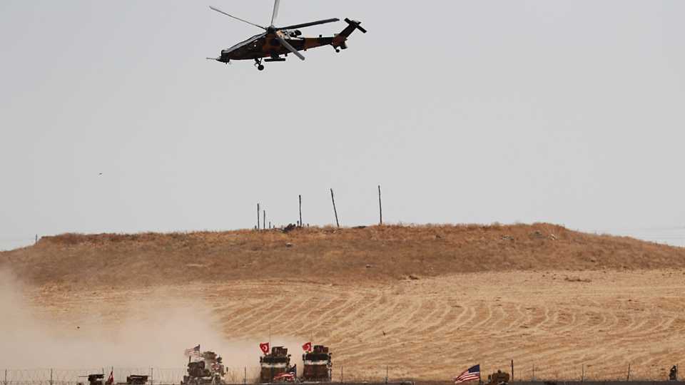 A Turkish military helicopter flies over as Turkish and US troops return from a joint US-Turkey patrol in northern Syria, as it is pictured from near the Turkish town of Akcakale, Turkey. September 8, 2019.