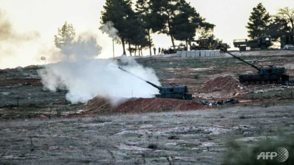 Tanks stationed at a Turkish Army position near the Oncupinar crossing gate close to the Turkish border town of Kilis fire towards the Syria border, on Feb 16, 2016.