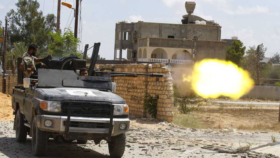 A fighter loyal to the UN-backed Libyan Government of National Accord fires a truck-mounted gun during clashes with forces loyal to warlord Khalifa Haftar in the capital Tripoli's suburb of Ain Zara on September 7, 2019.
