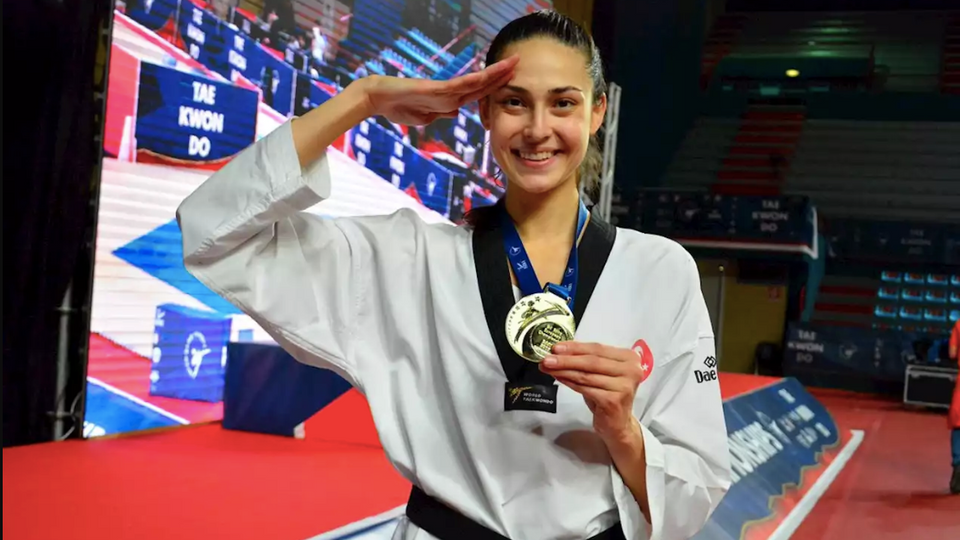 Irem Yaman performs a salute after winning a gold medal.