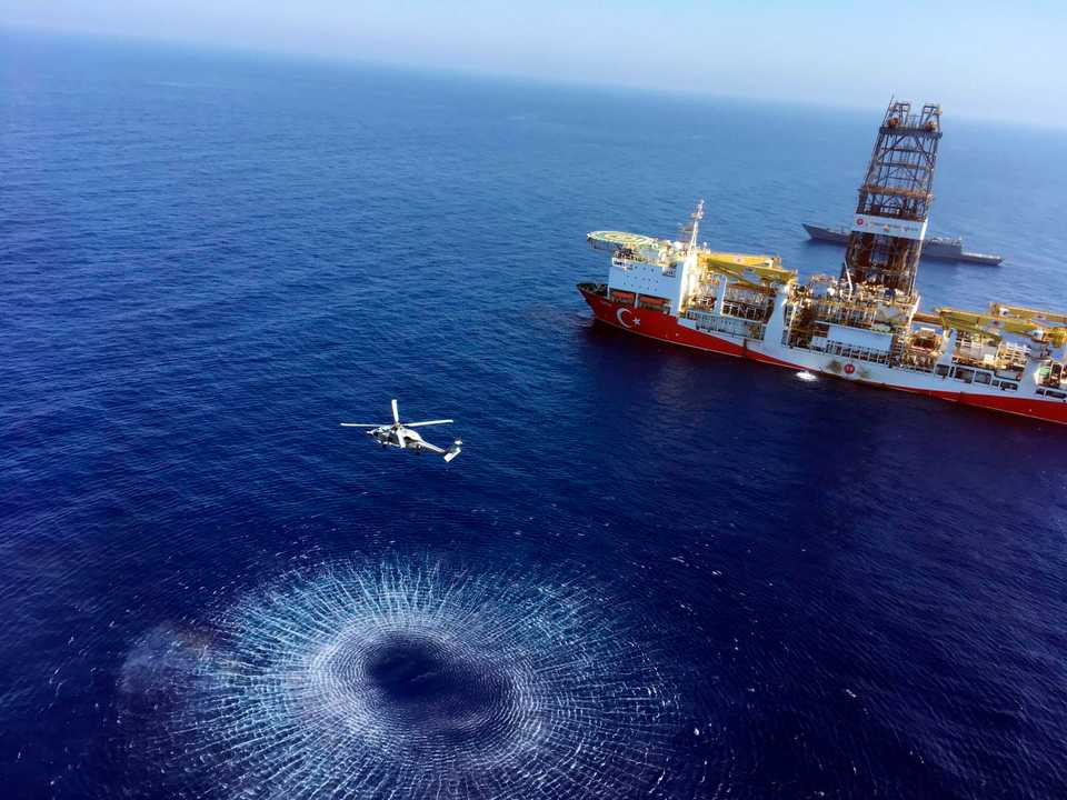 In this Tuesday, July 9, 2019 photo, a helicopter flies near Turkey's drilling ship, 'Fatih' dispatched towards the eastern Mediterranean, near the Turkish Republic of Northern Cyprus.