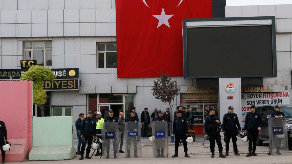 Sanliurfa's Suruc district Mayor Hatice Cevik was arrested as part of ongoing terrorism investigations, provincial prosecutors said. In this picture from November 15, 2019, police can be seen surrounding the Suruc Municipality building as a police search continues inside.