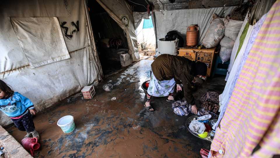 Turkey said it is investing in infrastructure for Syrians forced to live as refugees. In this file photo from November 3, 2019, Syrian refugees who fled the Assad regime's assault struggle with life in Kefernahum camp, northeast of Idlib, as winter arrives.