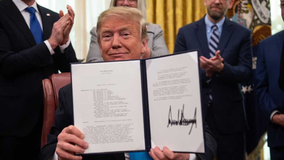 In this file photo taken on February 19, 2019, US President Donald Trump shows his signature on the Space Policy Directive-4 (SPD-4) at the White House in Washington, DC.