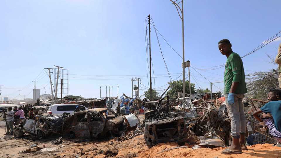 In this file image, a Somali man stands at the scene of a truck bomb explosion at a checkpoint in Mogadishu, Somalia on December 28, 2019.