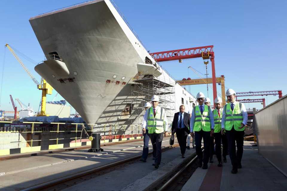 Turkish officials visit to see the construction of TCG Anadolu, Turkey's first aircraft carrier built by a native company, in Istanbul's Tuzla port in November 2019.