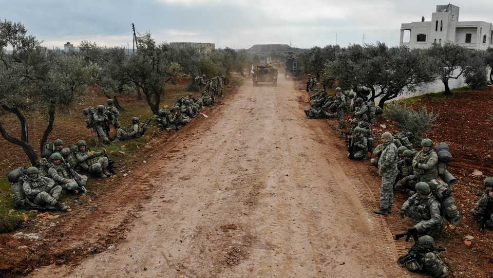 An aerial view shows Turkish soldiers gathering in the village of Qaminas, about six km southeast of Idlib city in northwestern Syria on February 10, 2020.