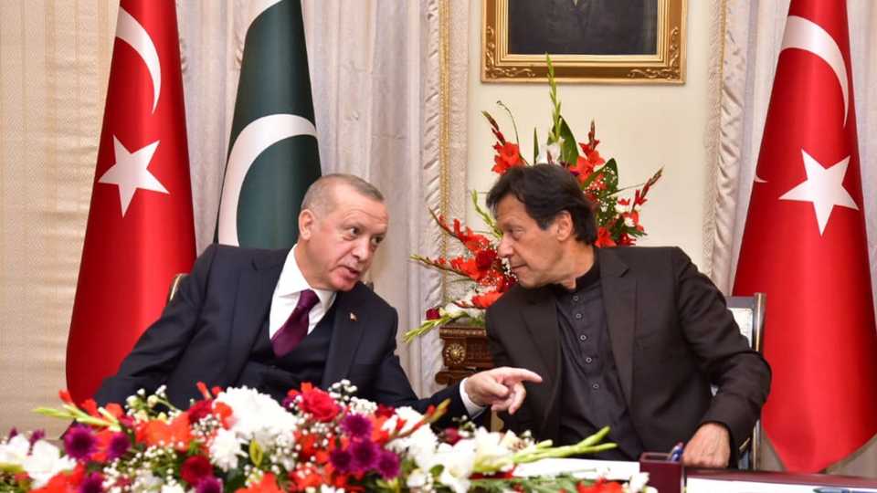 Pakistan's Prime Minister Imran Khan (R) and Turkish President Tayyip Erdogan share a light moment during an agreement signing ceremony in Islamabad, Pakistan, February 14, 2020.