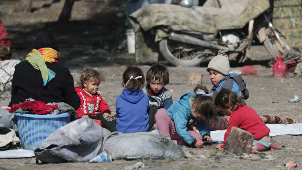 Internally displaced children sit at a makeshift camp in Qatmah village, in northwest Azaz, Syria, February 17, 2020.