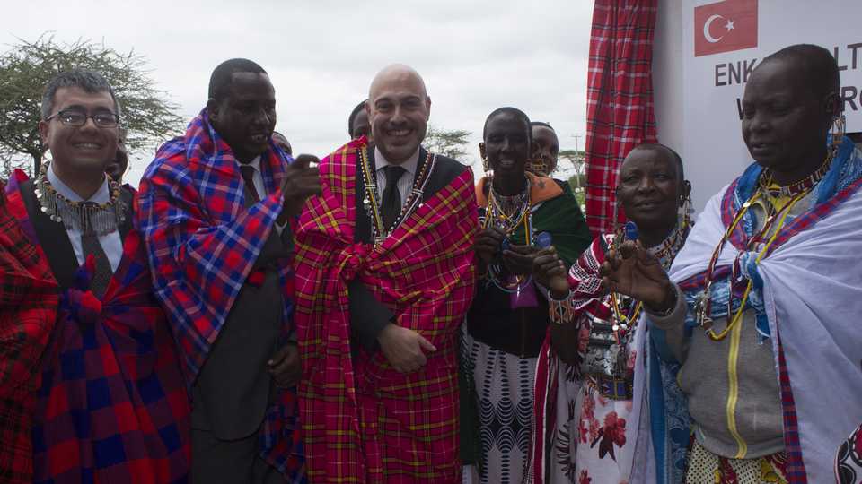Turkish Ambassador to Kenya Ahmet Cemil Miroglu stands alongside Kenyans during an opening ceremony of a water-well in Kajiado, Kenya. July 23, 2019.
