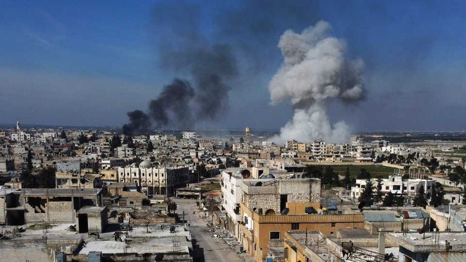 Smoke billows over the town of Saraqeb in the eastern part of Idlib province in northwestern Syria, following bombardment by Syrian regime forces, on February 27, 2020.