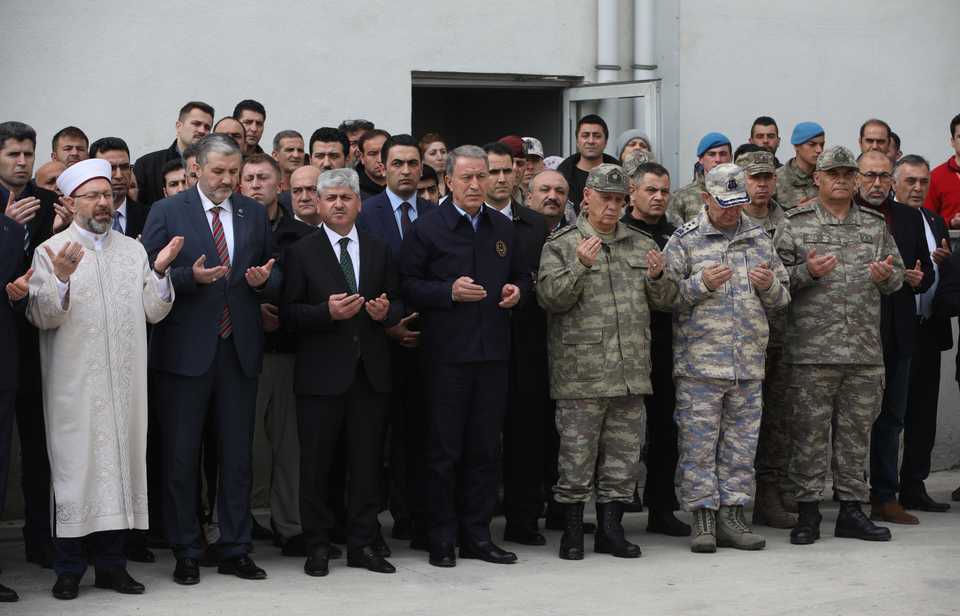 Turkey’s national defence minister, Hulusi Akar, accompanied by Turkish army officials, prays for the soldiers killed in the Syrian regime attack in Idlib.