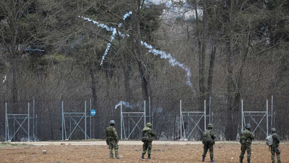 Soldiers stand guard as tear gas is being fired near Turkey's Pazarkule border crossing in Kastanies, Greece. March 4, 2020.