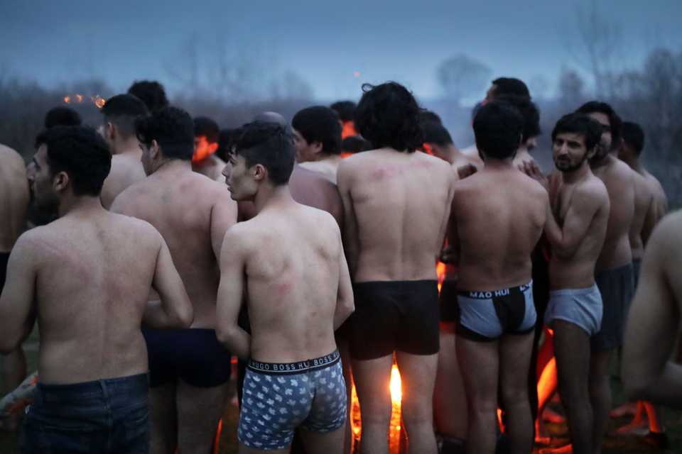 Refugees in no man's land between Greece and Turkey near Edirne show marks on their backs which they report sustaining in beatings by Greek border officials. March 4-5, 2020. (Belal Khaled / TRT Arabi)