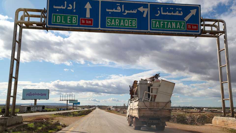 A truck loaded with a family's belongings drives along the Aleppo-Latakia highway near the town of Saraqeb, Idlib province, Syria, January 31, 2020.