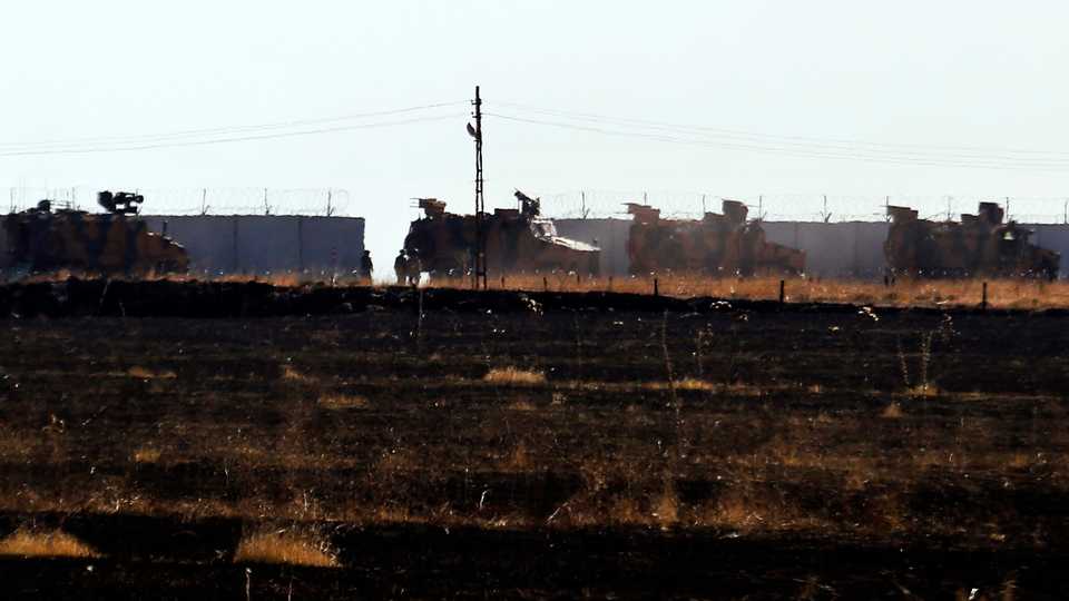 In this photo taken from the outskirts of the village of Alakamis, in Idlib province, southeastern Turkey, Turkish army vehicles return to Turkey from Syria after conducting a joint patrol with Russian forces, November 8, 2019.