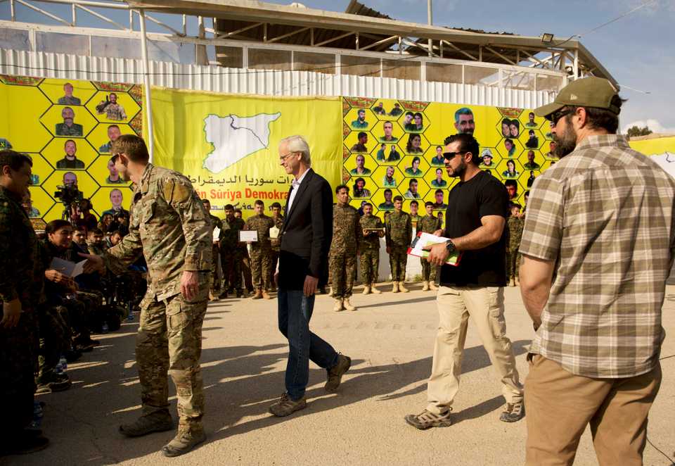 US envoy William Roebuck, centre leaves the podium after speaking at an event organised by US-backed SDF in Baghouz, at al-Omar Oil Field base, Syria, March 23, 2019.