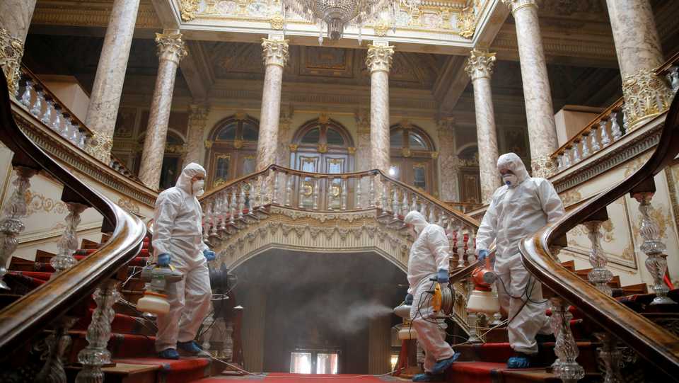 Workers in protective suits disinfect Dolmabahce Palace due to coronavirus concerns in Istanbul, Turkey March 11, 2020.