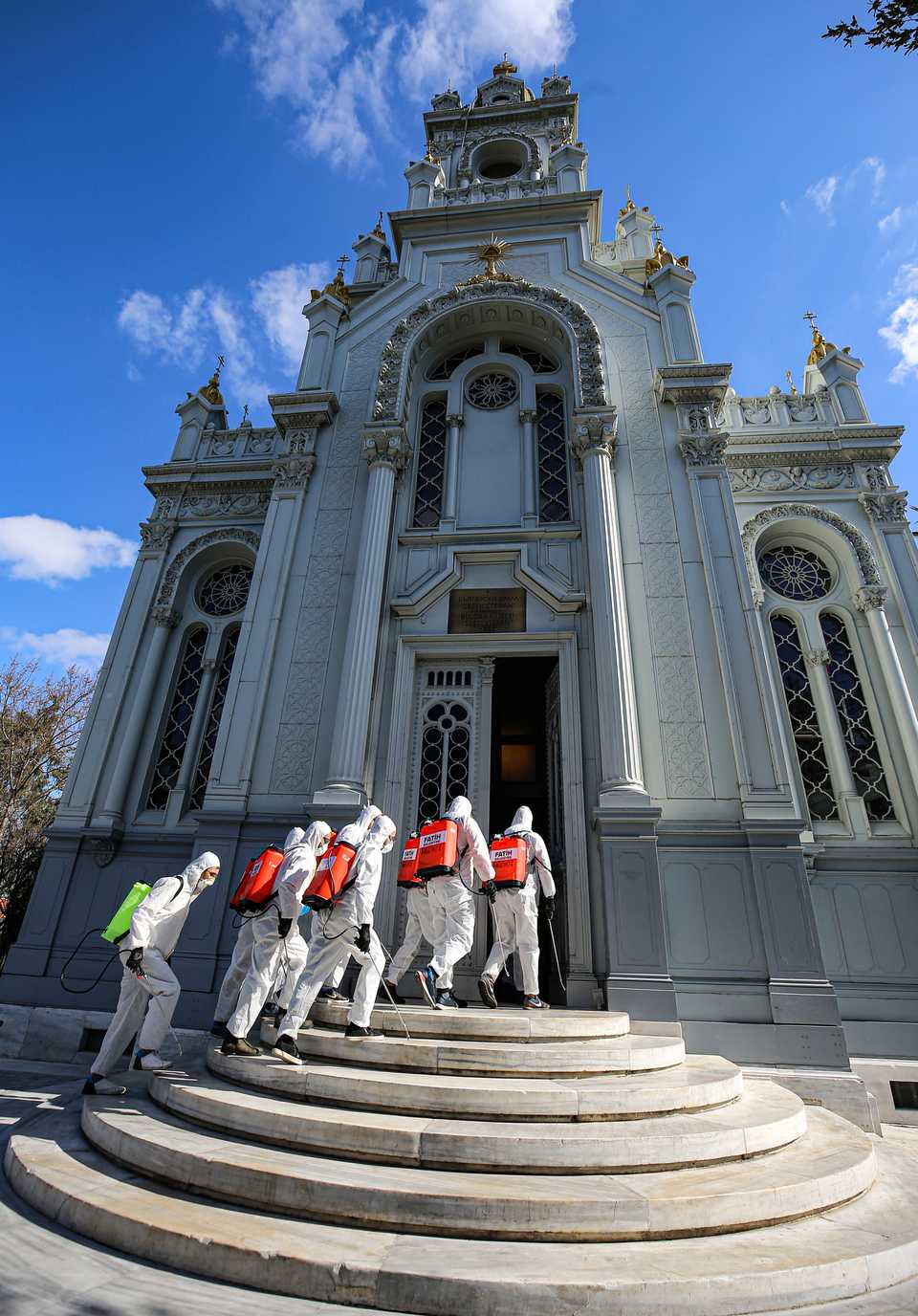 Workers in hazard gear move in to disinfect Sveti Stefan Church at Balat district as part of a campaign against the Covid-19 virus