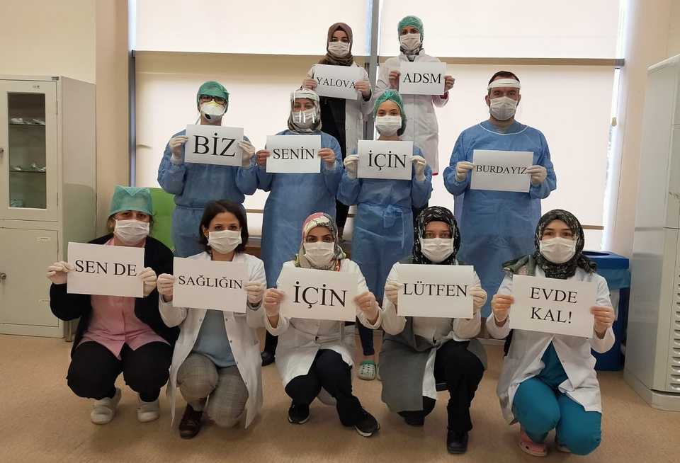 The picture shows health workers holding banners saying that 