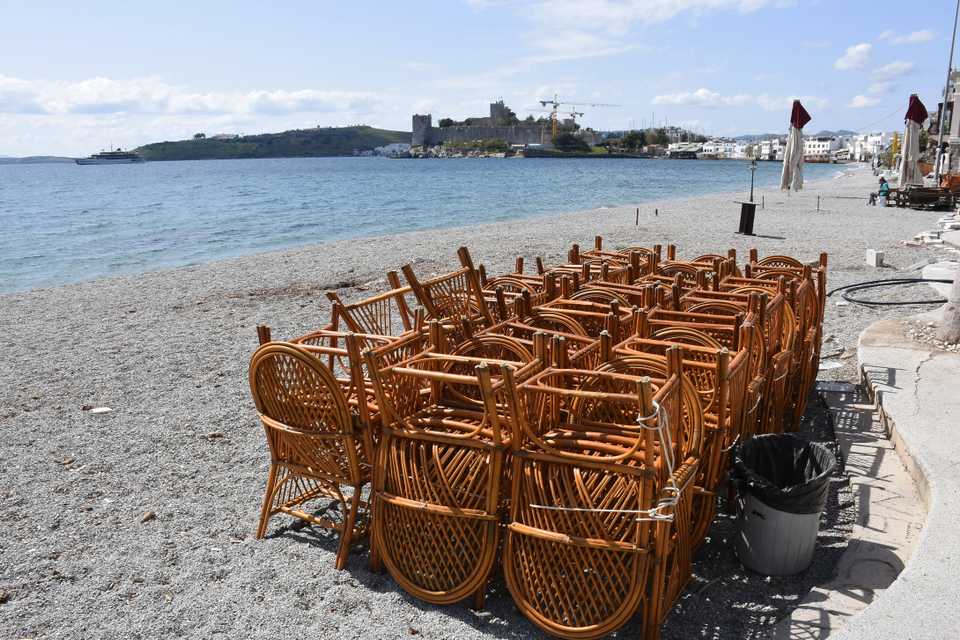 The picture shows gathered seats of a cafeteria at the beach next to historic Bodrum Castle on 23 March, 2020, Bodrum district of Mugla, Turkey.